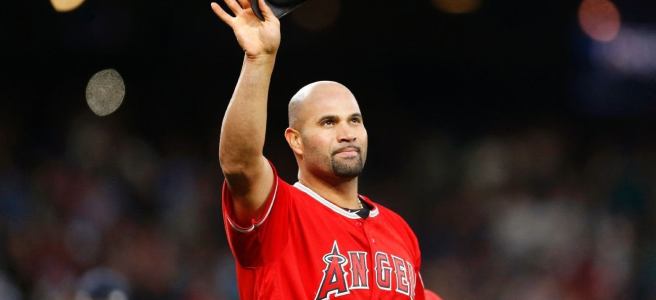 A baseball player in an Angels jersey waves to the crowd.