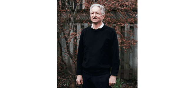Geoffrey Hinton standing in a backyard.